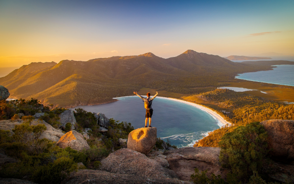 A man standing looking over Wineglass Bay Tasmania