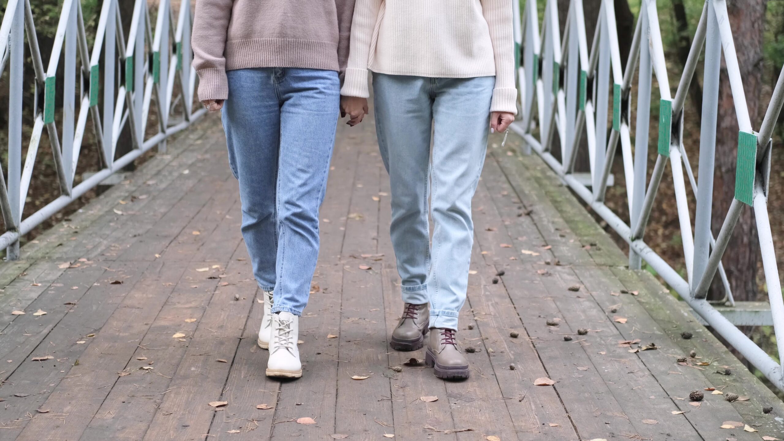 Two people walking on a bridge side by side to show walk and talk support